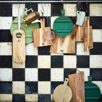 checkered back splash in black and white with wooden cutting boards on rack