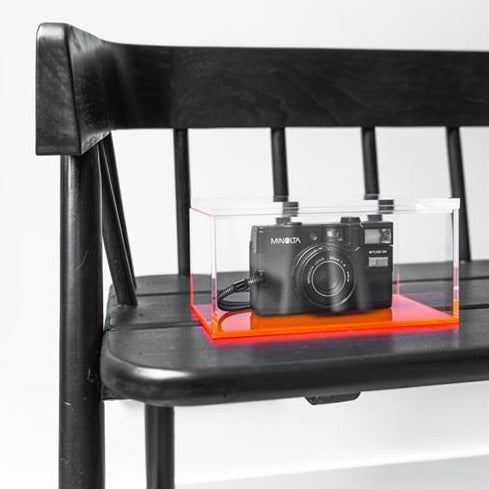 detail of handpainted, black garden bench with photo camera