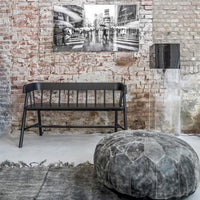 loft with exposed brick wall and black garden bench in wood by hk living and black leather pouf